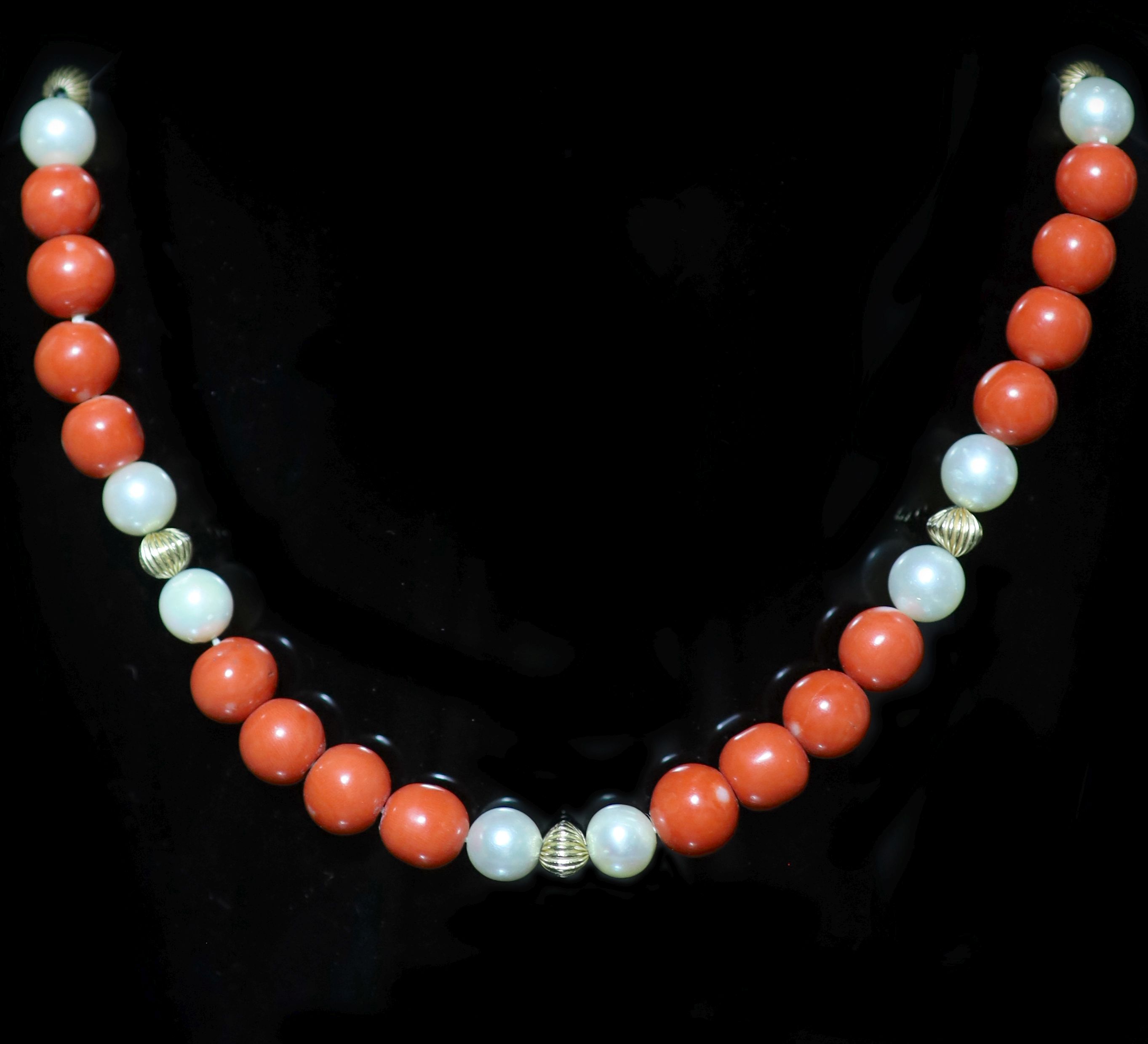 A coral bead and cultured pearl necklace with 14K yellow gold clasp,
